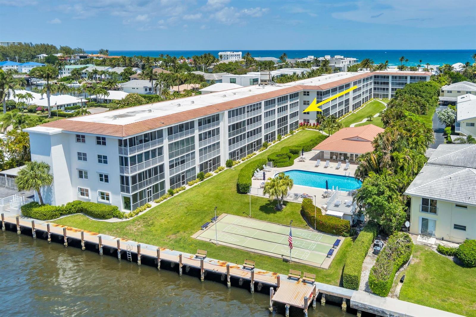 An aerial view of a multi-story apartment building with a pool and waterfront dock — 1910 S Ocean Boulevard # 224, Delray Beach FL 33483, DELRAY BEACH, FL