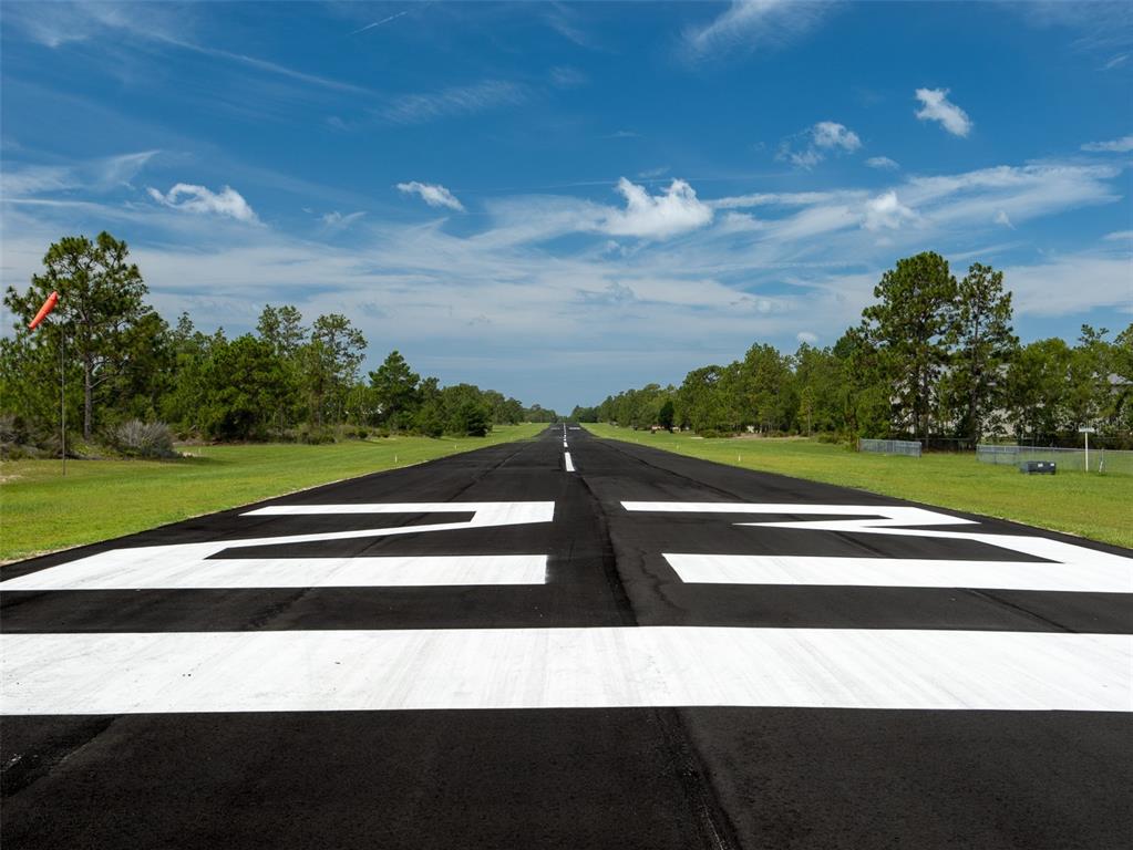 A view down a paved airport runway marked with the number 23 — 267 MELROSE LANDING DRIVE, HAWTHORNE, FL