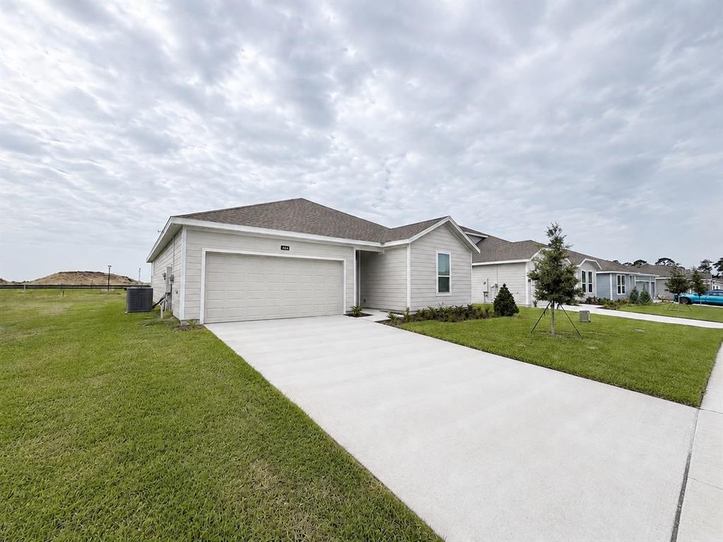 A light-colored single-story house with a two-car garage and a concrete driveway — 644 RUTH AVENUE, HAINES CITY, FL