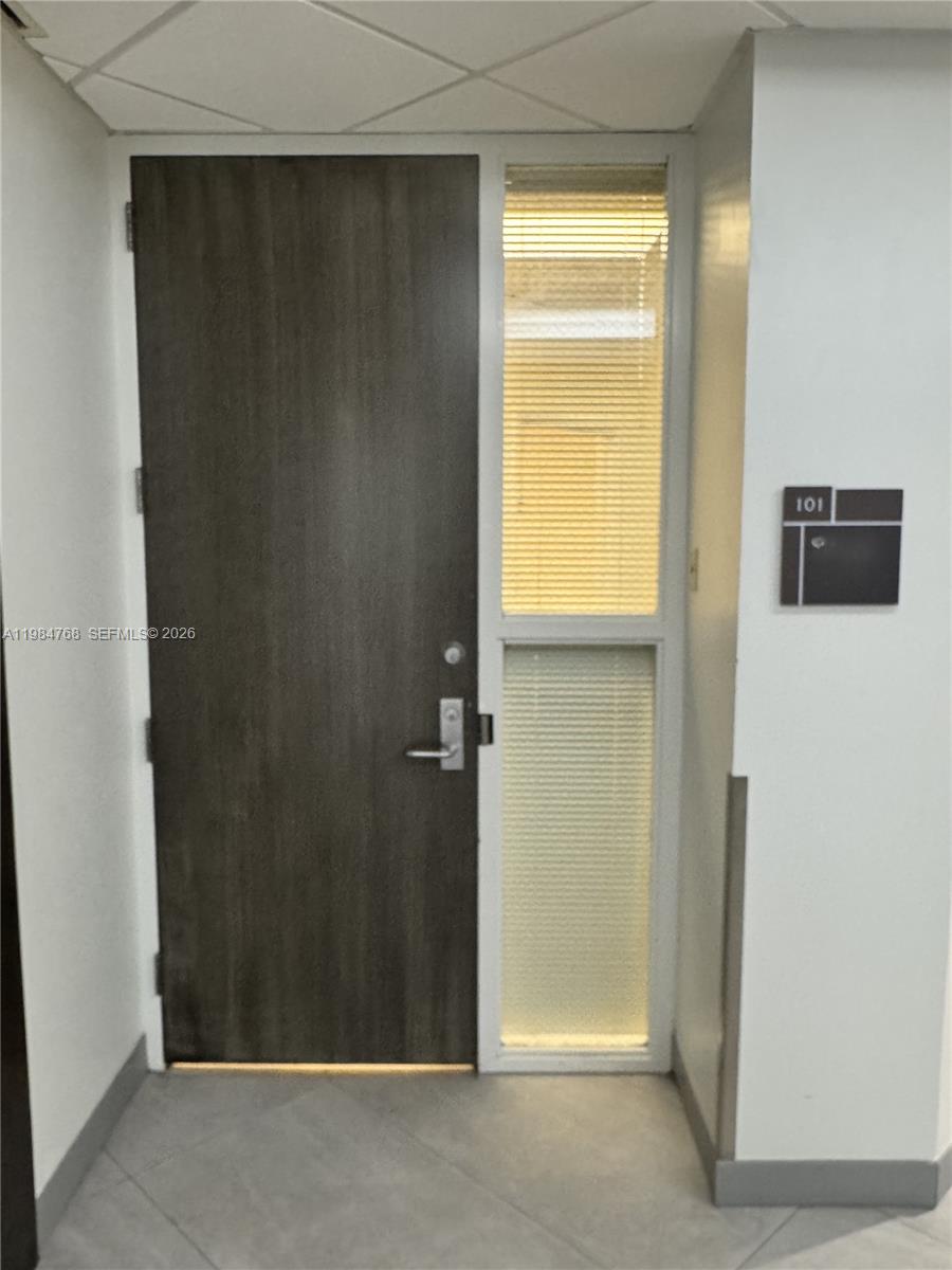 A dark wood door with a side window panel and a room number sign — 5959 Waterford District Dr # 101, Miami FL 33126, MIAMI, FL