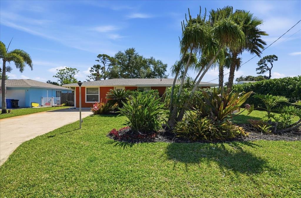 A single-story orange house with a driveway and palm trees in the front yard — 1129 RIVIERA STREET, VENICE, FL