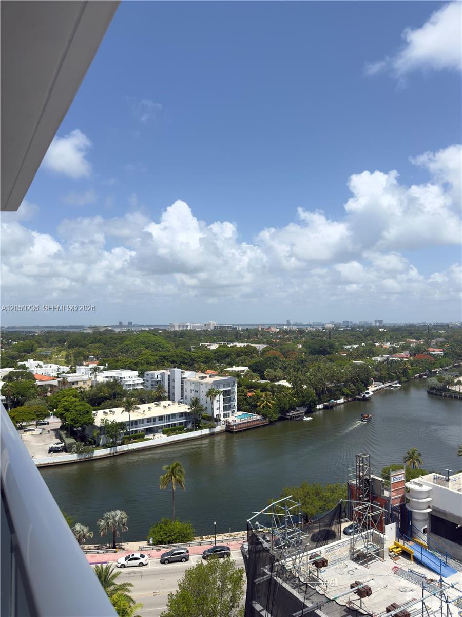 An elevated view shows a waterway, surrounding buildings, lush trees, and a construction site — 2401 Collins Ave # 1612, Miami Beach FL 33140, MIAMI BEACH, FL