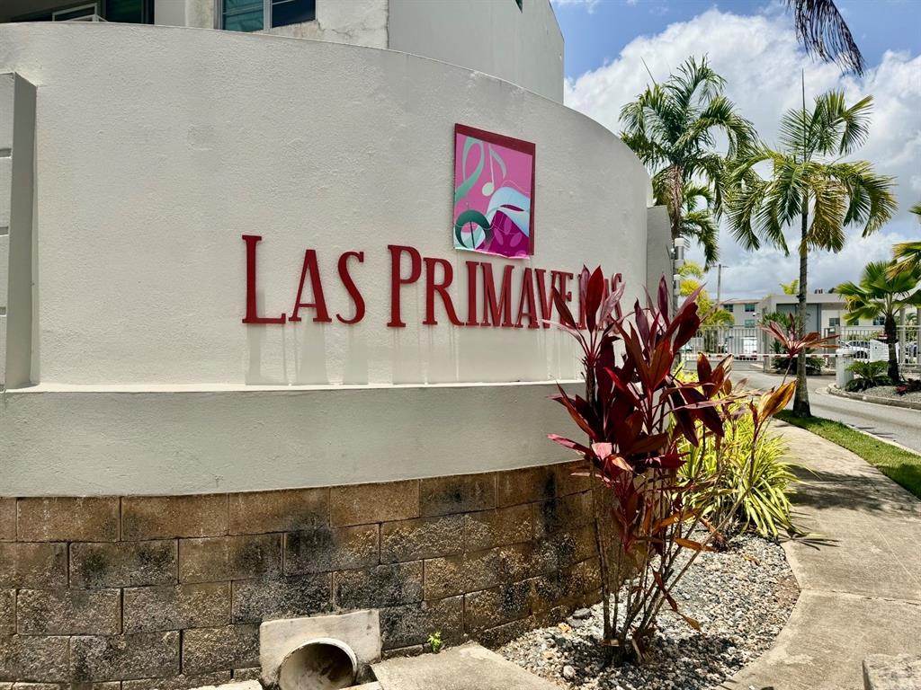 A curved wall displays the name Las Primaves with a logo above a stone base — Apt 1805 CONDOMINIO LAS PRIMAVERAS UNIT 1805, CAROLINA, PR