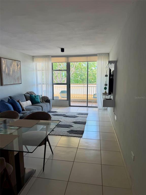 A living room with tile floors, a gray sofa, and a glass dining table — Apt 1805 CONDOMINIO LAS PRIMAVERAS UNIT 1805, CAROLINA, PR