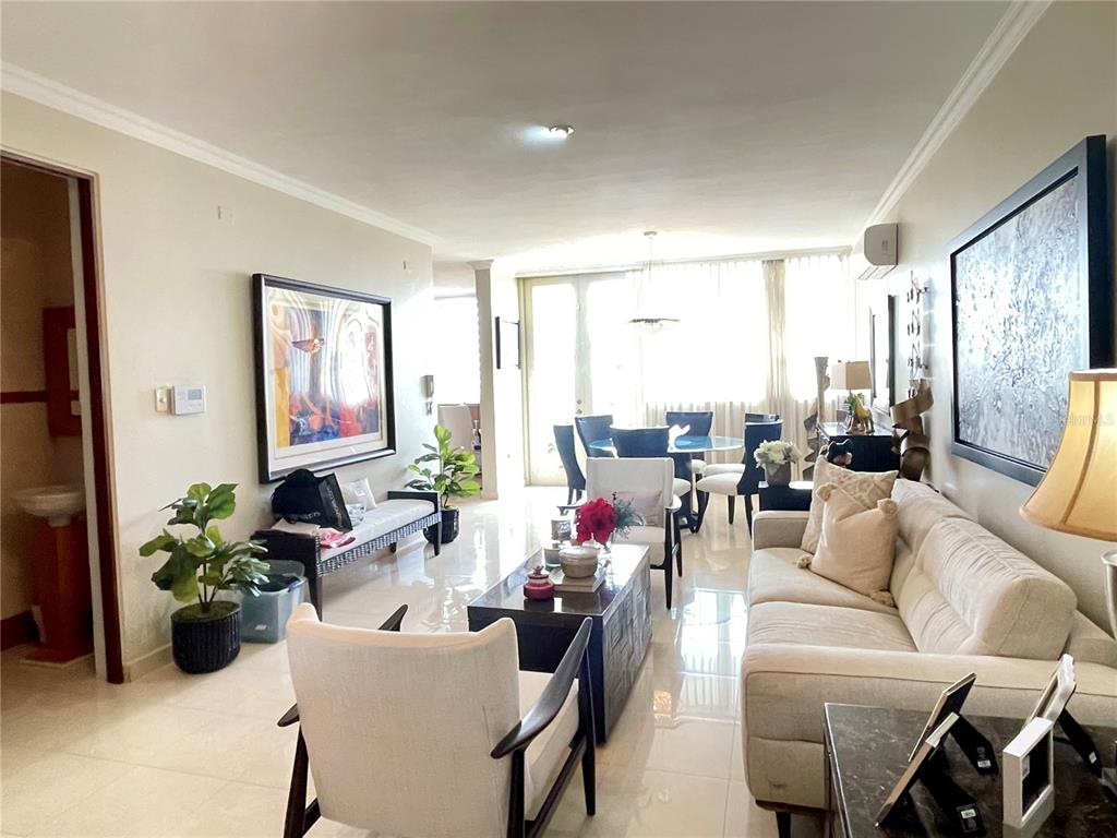 A living room with a beige sofa, armchairs, a coffee table, and a dining area — Palma Real Avenue MURANO LUXURY APARTMENTS UNIT 8, GUAYNABO, PR