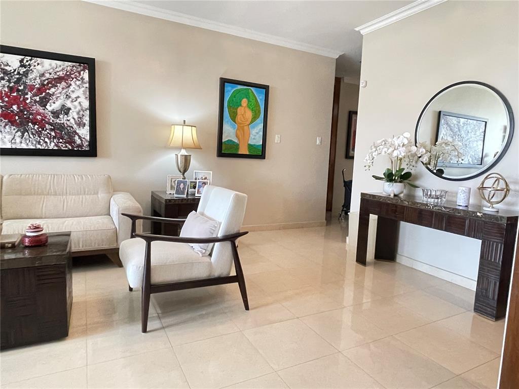 A living room features light tile floors, a sofa, an armchair, and a console table — Palma Real Avenue MURANO LUXURY APARTMENTS UNIT 8, GUAYNABO, PR