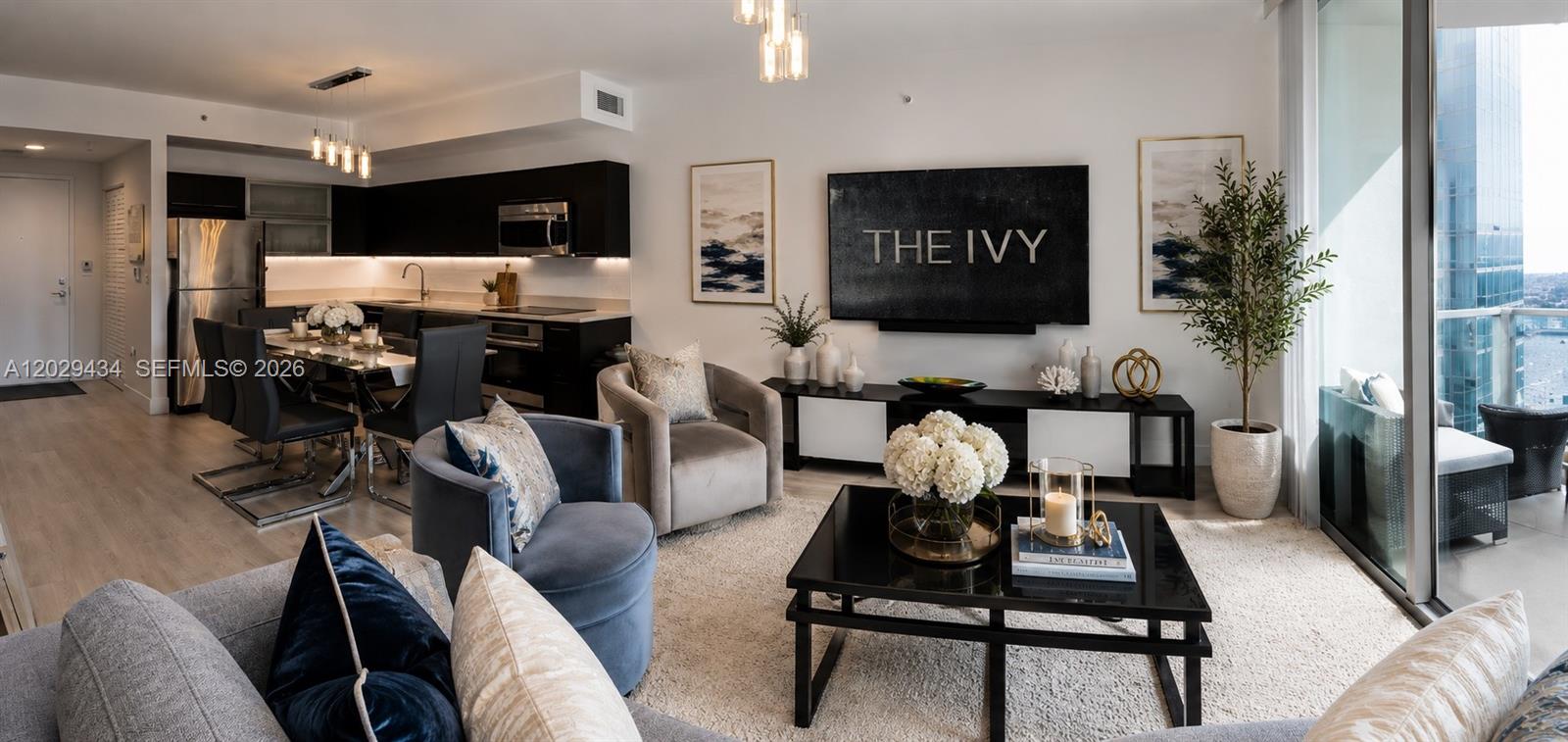 A modern living room and dining area feature dark cabinetry, neutral furniture, and balcony views — 90 SW 3rd St # 1703, Miami FL 33130, MIAMI, FL