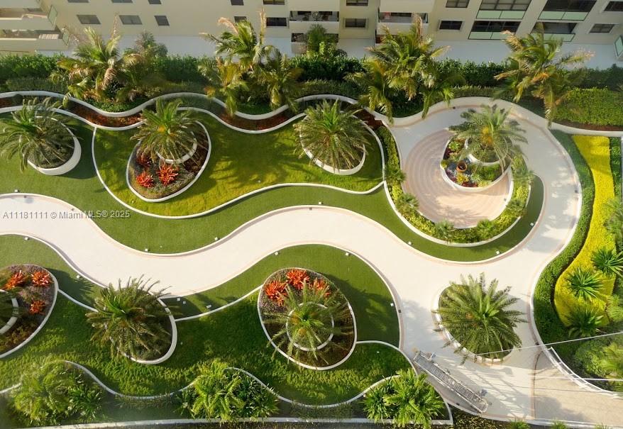 An aerial view shows a landscaped courtyard with curved walkways, manicured lawns, and palm trees — 100 Lincoln Rd # 1642, Miami Beach FL 33139, MIAMI BEACH, FL