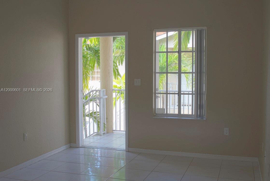 A room with white tile floors, a glass door to a balcony, and a window — 6962 NW 179th St # 6, Hialeah FL 33015, HIALEAH, FL