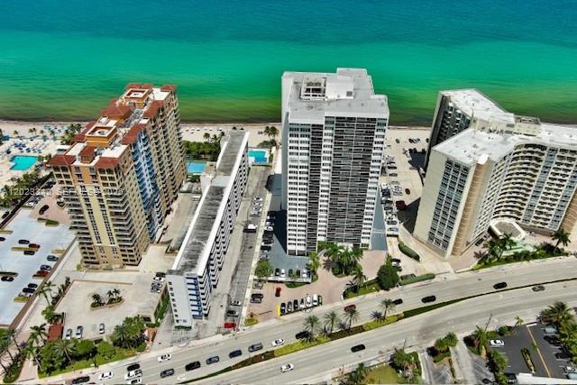 An aerial view shows three high-rise apartment buildings situated along a sandy beach and ocean — 3140 S Ocean Dr # 1210, Hallandale Beach FL 33009, HALLANDALE BEACH, FL