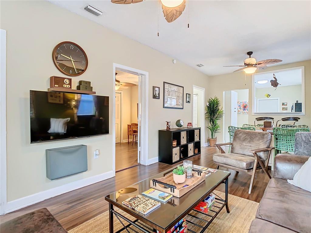 A living room features a wall-mounted television, a coffee table, and an adjacent dining area — 2904 SANCHEZ STREET, TAMPA, FL