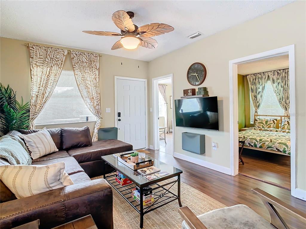 A living room features a brown sectional sofa, a glass coffee table, and a ceiling fan — 2904 SANCHEZ STREET, TAMPA, FL