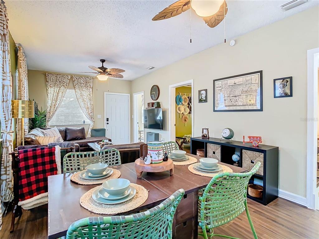 A dining area with green chairs and a living room with a sofa are visible — 2904 SANCHEZ STREET, TAMPA, FL