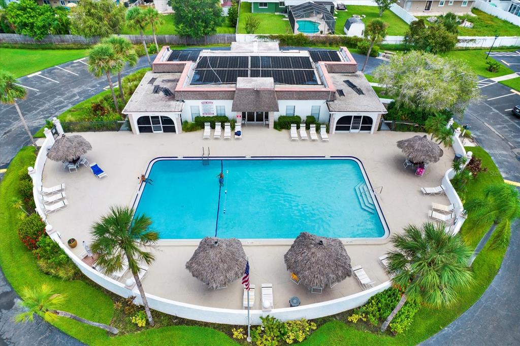 An aerial view shows a rectangular swimming pool surrounded by lounge chairs and tiki umbrellas — 235 S MCMULLEN BOOTH ROAD UNIT 45, CLEARWATER, FL