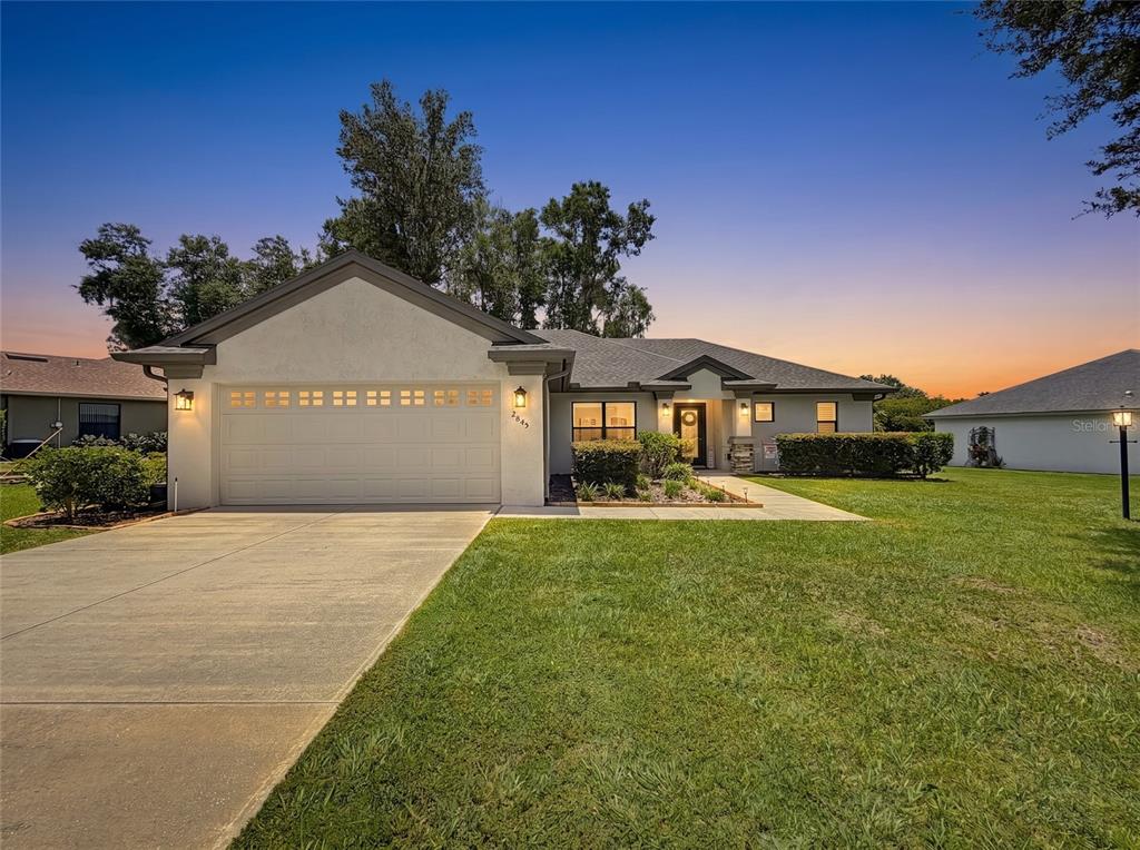 A single-story house with a two-car garage, concrete driveway, and a manicured front lawn — 2845 N APPLEDORE PATH, HERNANDO, FL