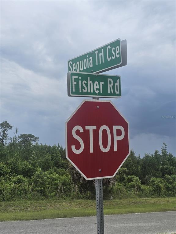 A stop sign stands below street signs for Sequoia Trl Cse and Fisher Rd — Lot 1 FISHER ROAD, OCKLAWAHA, FL