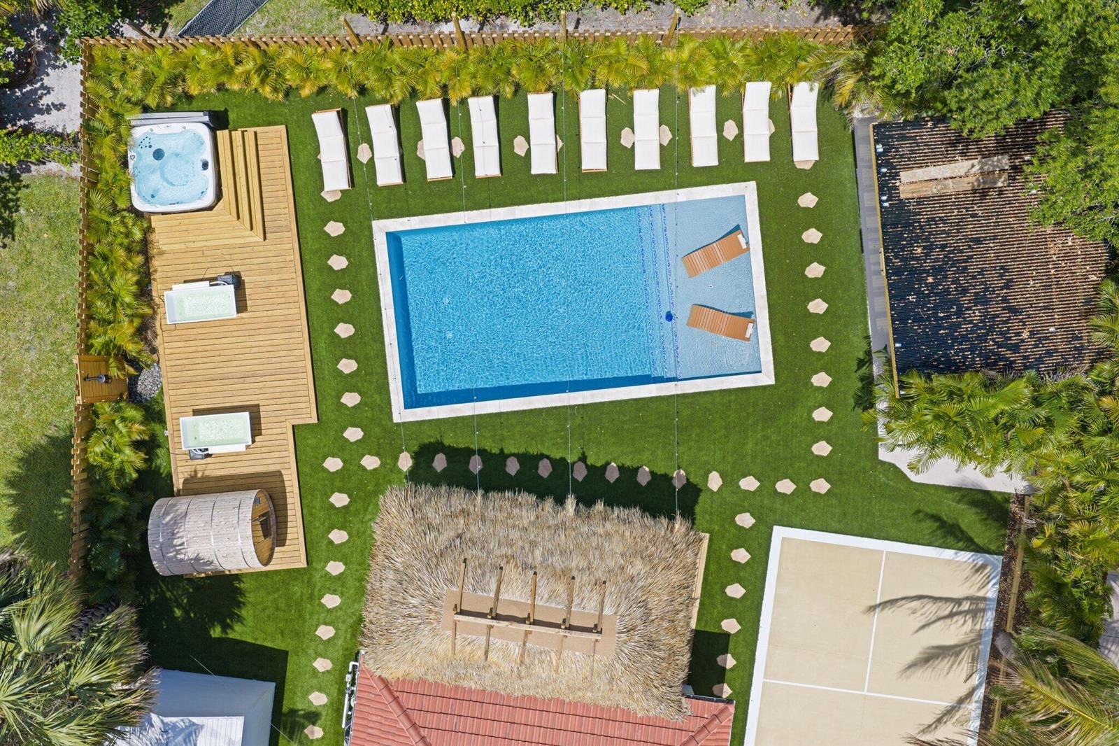 An aerial view shows a backyard with a swimming pool, hot tub, sauna, and patio — 275 NE 16th Street, Delray Beach FL 33444, DELRAY BEACH, FL
