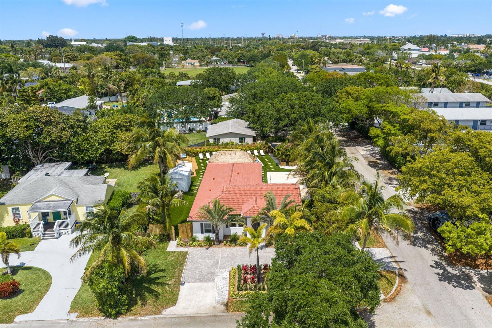 An aerial view shows a single-story house with a red tile roof and palm trees — 275 NE 16th Street, Delray Beach FL 33444, DELRAY BEACH, FL