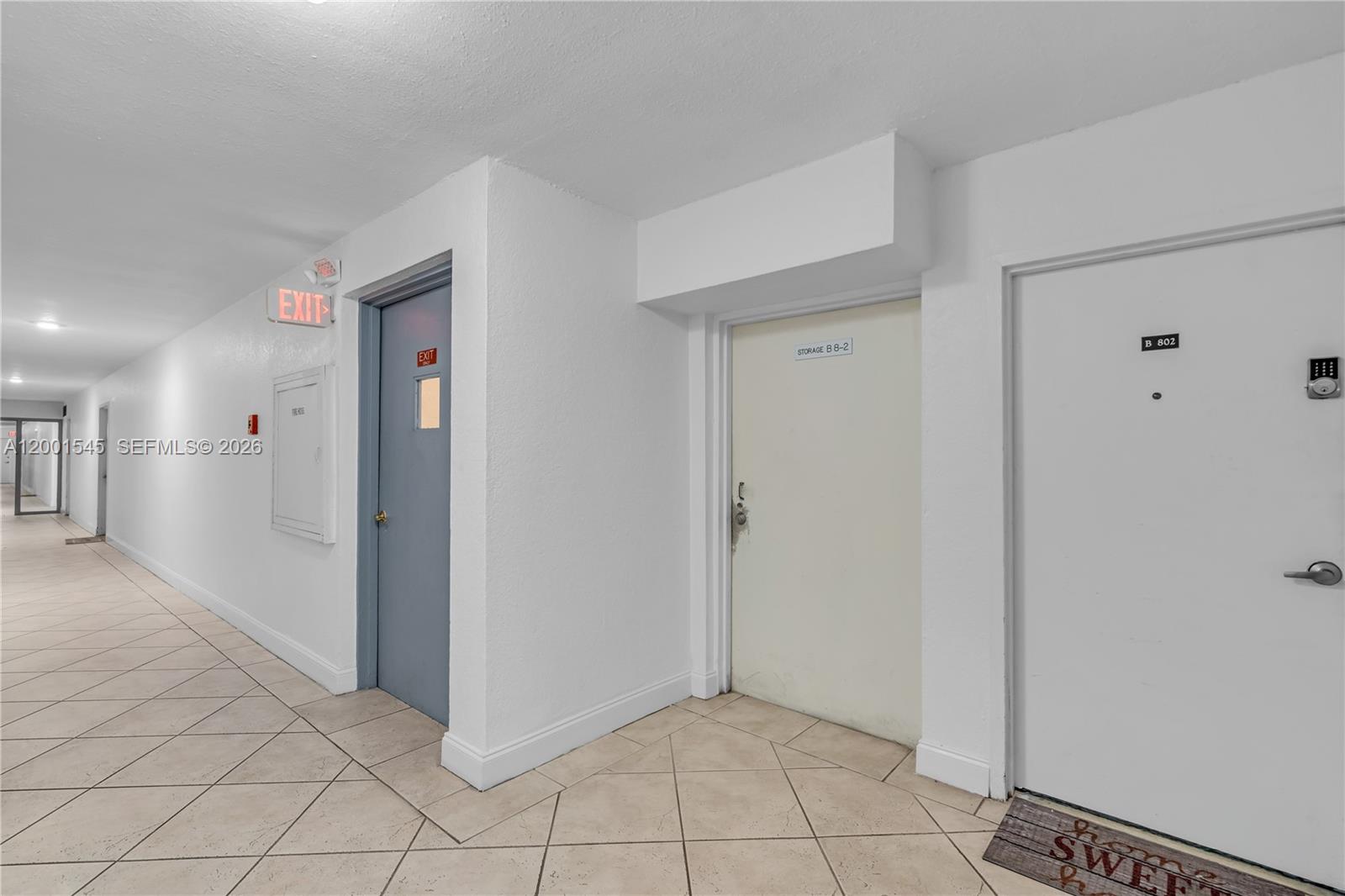 A hallway features tiled floors, a gray exit door, a storage door, and unit 802 — 9143 SW 77th Ave # B802, Miami FL 33156, MIAMI, FL