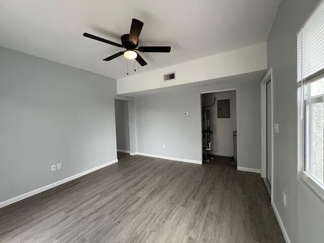 An empty room with gray walls, wood-look flooring, a ceiling fan, and a doorway — 520 N E Street, FL 33460, FL