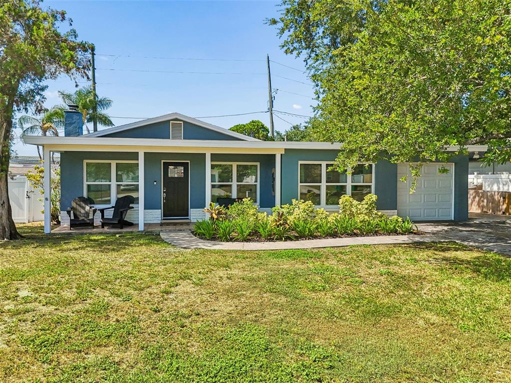 A dining room features a wooden table, white chairs, tile flooring, and a ceiling light — 10748 VILLAGE GREEN AVE, SEMINOLE, FL