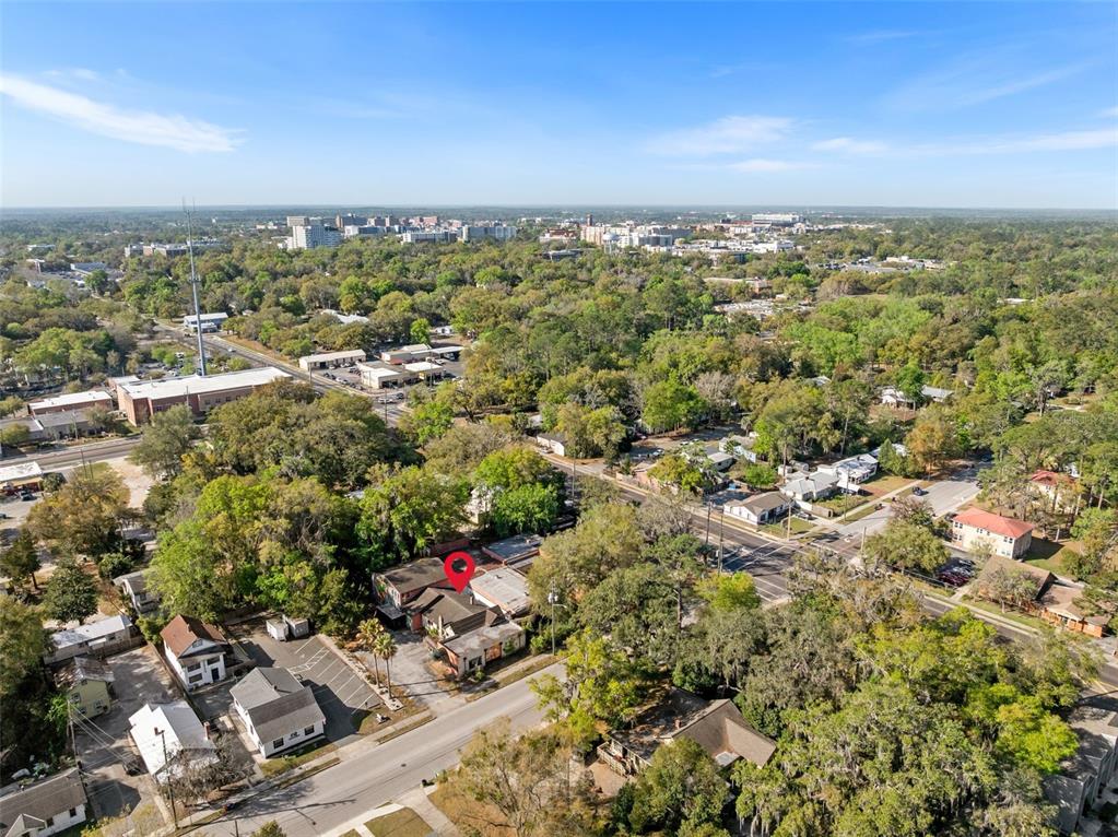 An aerial view shows a commercial building with a red location pin in a neighborhood — 519 NW 10TH AVENUE, GAINESVILLE, FL