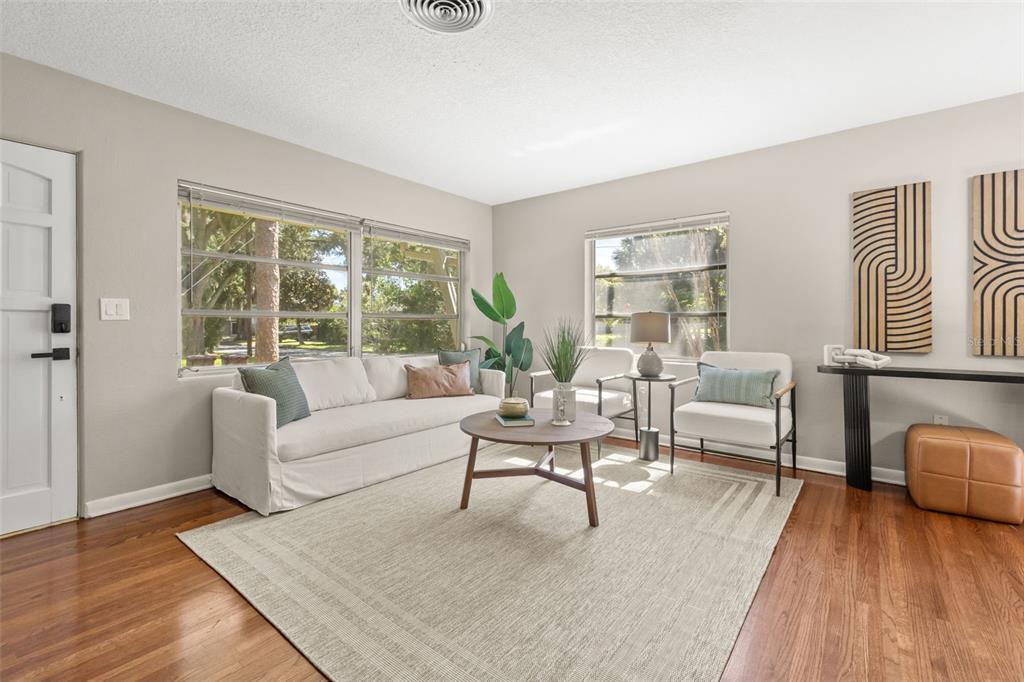 A living room features a white sofa, two armchairs, a coffee table, and hardwood floors — 820 RUGBY STREET, ORLANDO, FL
