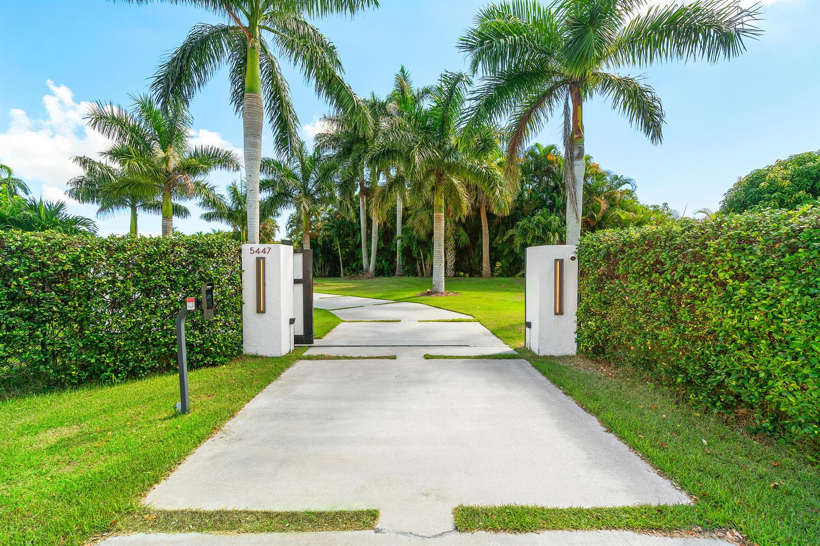 An aerial view shows several waterfront houses with swimming pools, palm trees, and large lawns — 5447 Center Street, Jupiter FL 33458, JUPITER, FL