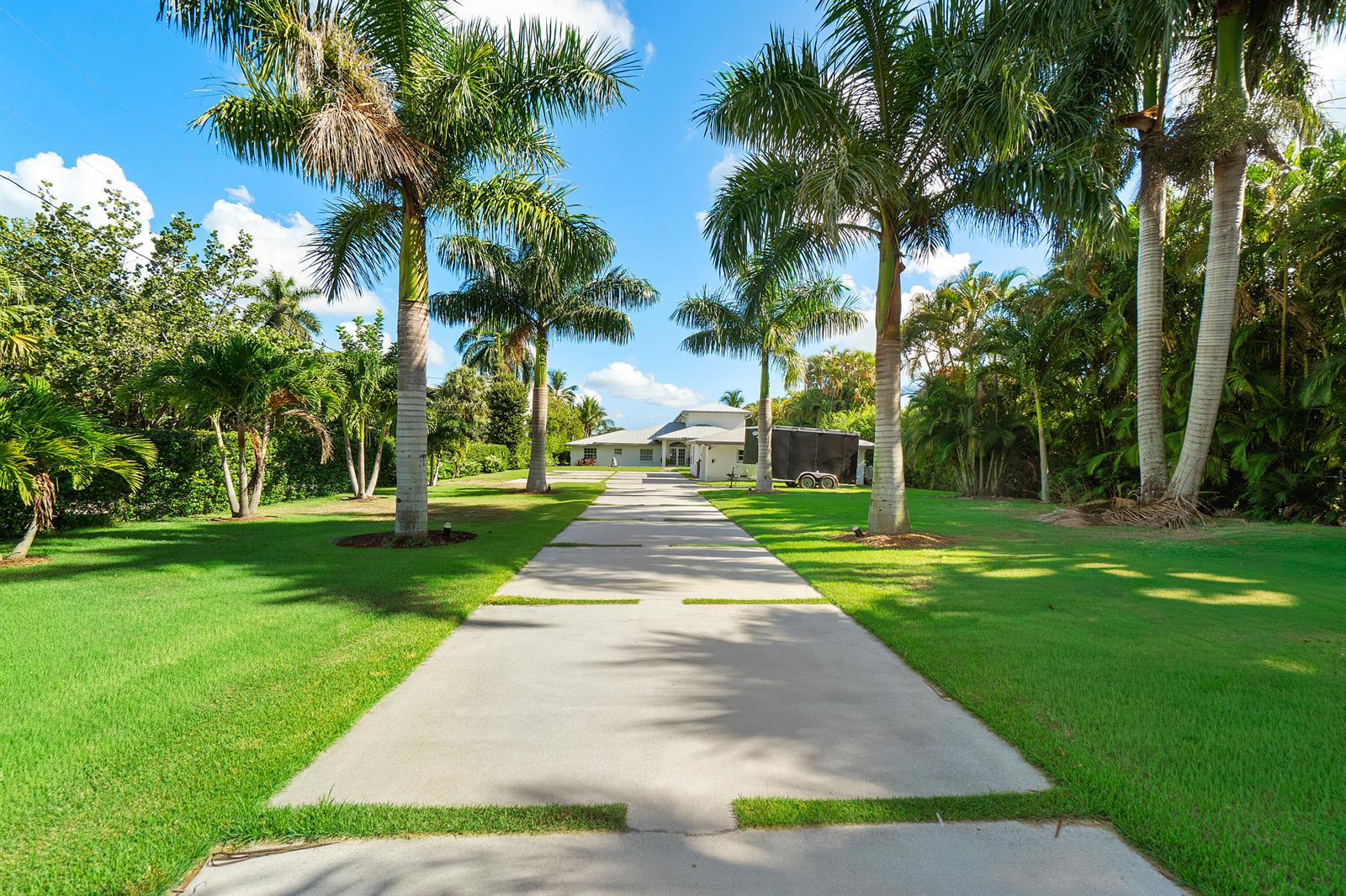 An aerial view shows a waterfront property with a long driveway and private boat dock — 5447 Center Street, Jupiter FL 33458, JUPITER, FL