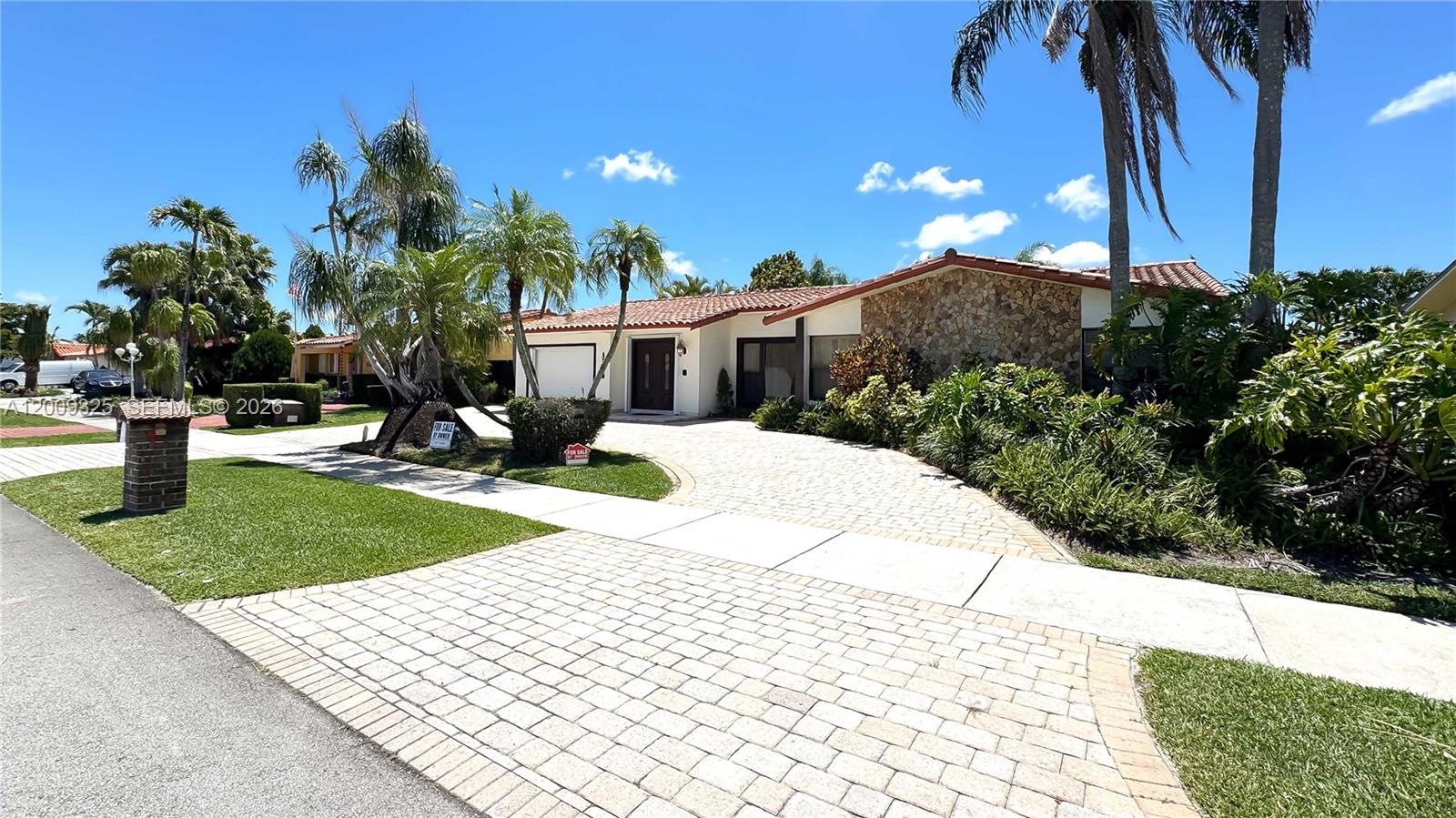A single-story house with a stone facade, tile roof, and a paved driveway — 13300 SW 21st St, Miami FL 33175, MIAMI, FL