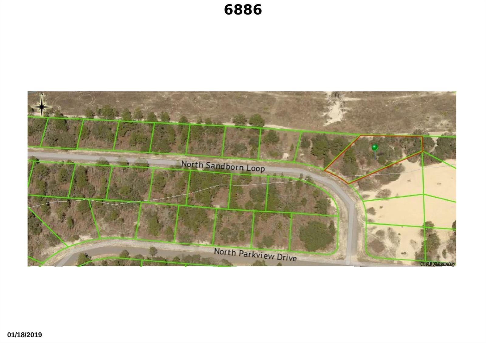 This is an aerial map showing a residential lot outlined in red on a street — 6886 N Sandborn Loop, FL 34433, FL