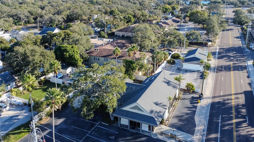 An aerial view shows a commercial building with a parking lot next to a road — 1201 S MYRTLE AVENUE, CLEARWATER, FL