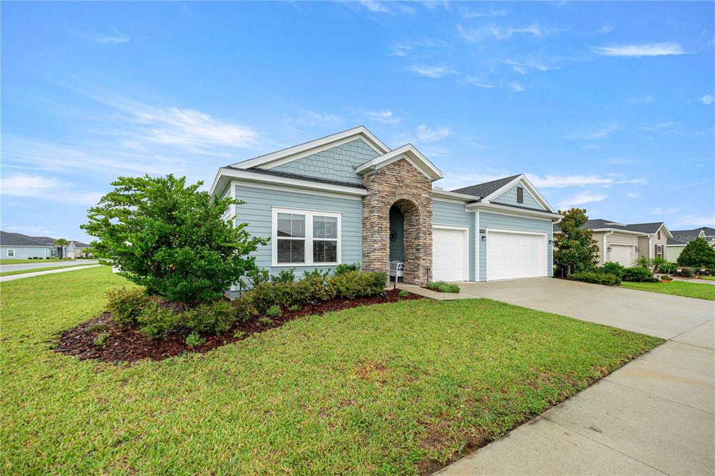 A front porch features light blue siding, a brown door, and a white bench — 9332 SW 58TH CIRCLE, OCALA, FL