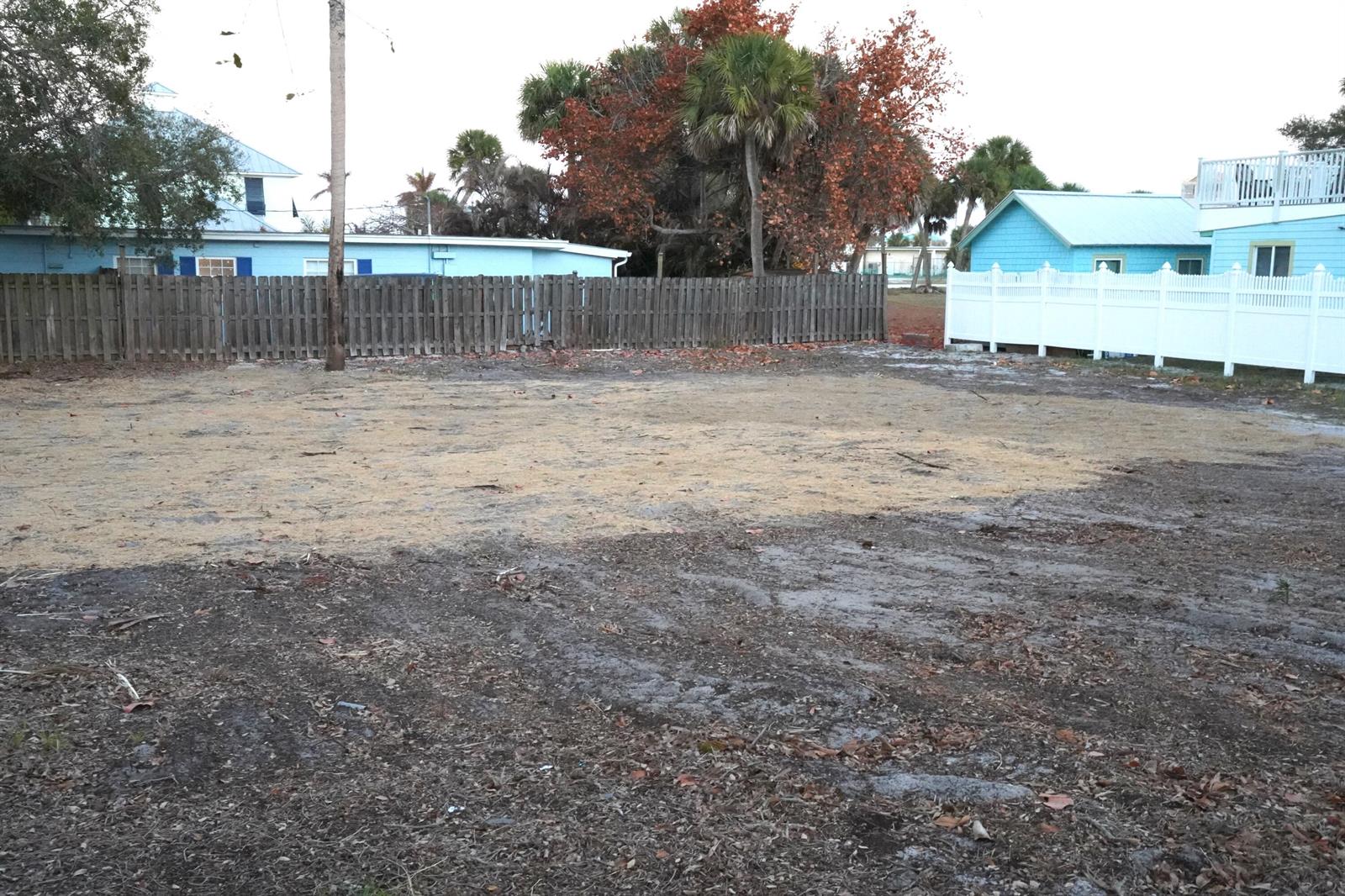 A vacant, cleared residential lot enclosed by wooden and white vinyl privacy fences — 109 D Avenue, Fort Pierce FL 34950, FORT PIERCE, FL