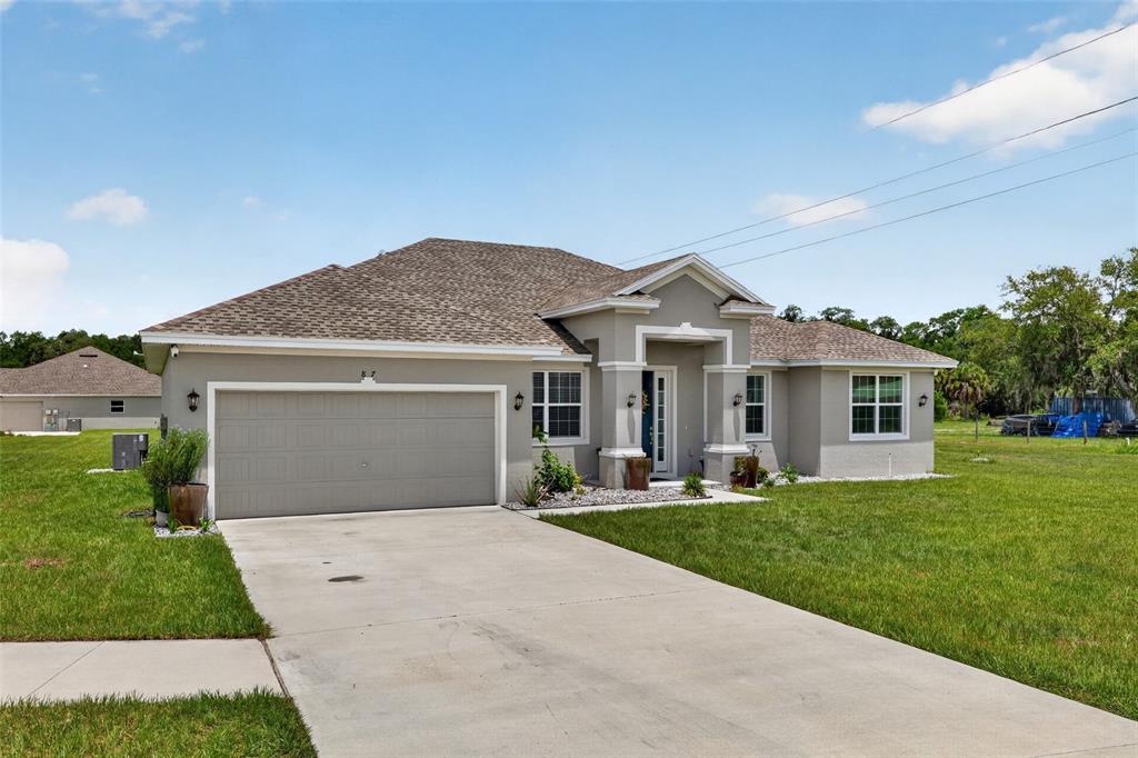 A single-story gray house with a two-car garage and a concrete driveway — 837 LIAM LANE, BARTOW, FL