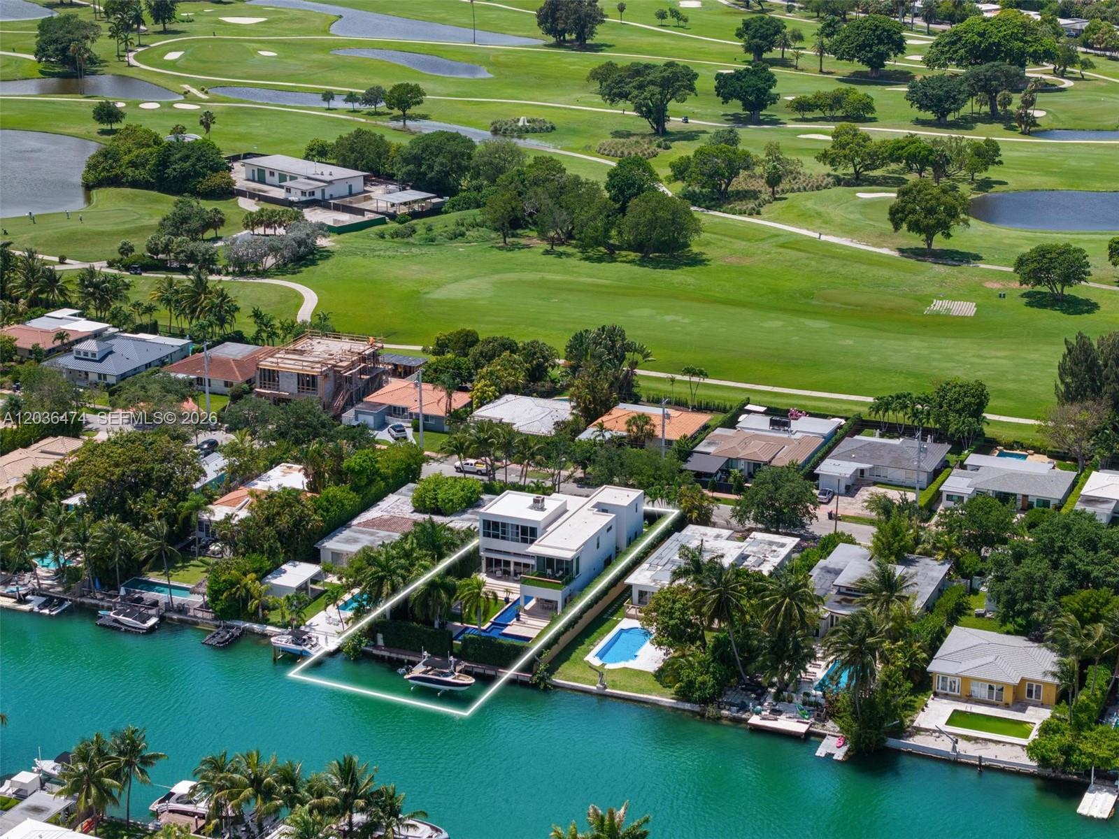 An aerial view shows a modern waterfront home with a pool and boat dock — 470 S Shore Dr, Miami Beach FL 33141, MIAMI BEACH, FL