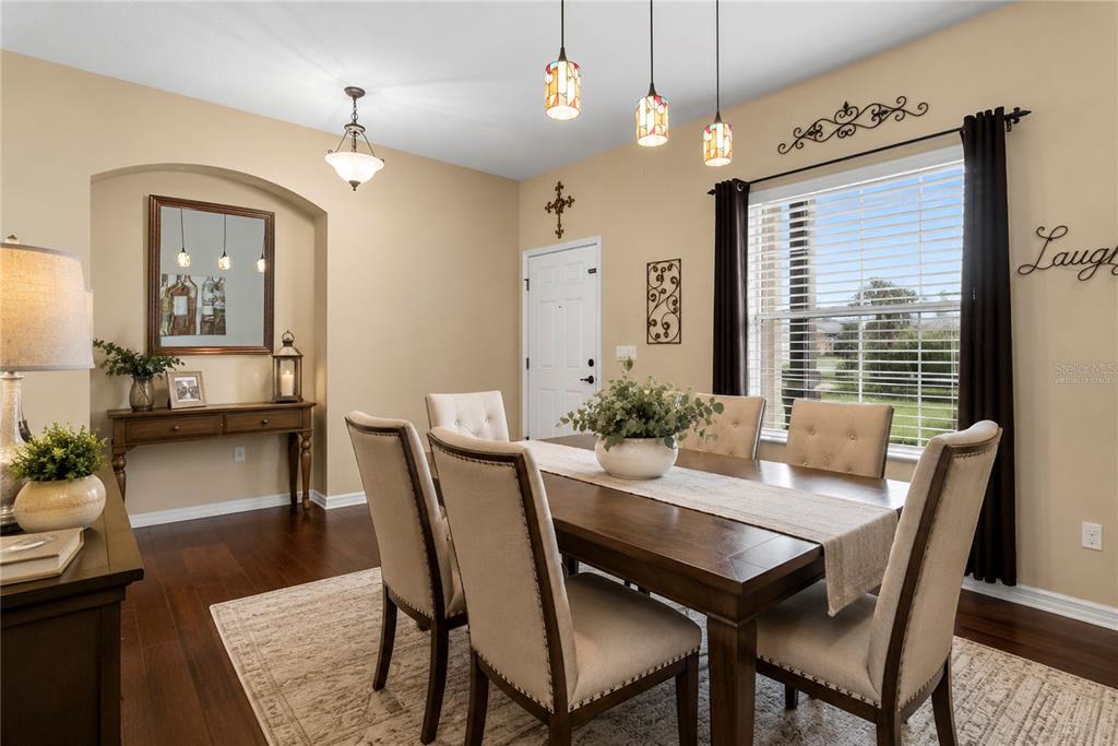 A living room features a white sectional sofa, a round coffee table, and tile flooring — 729 MEADOW GLADE DRIVE, WINTER GARDEN, FL