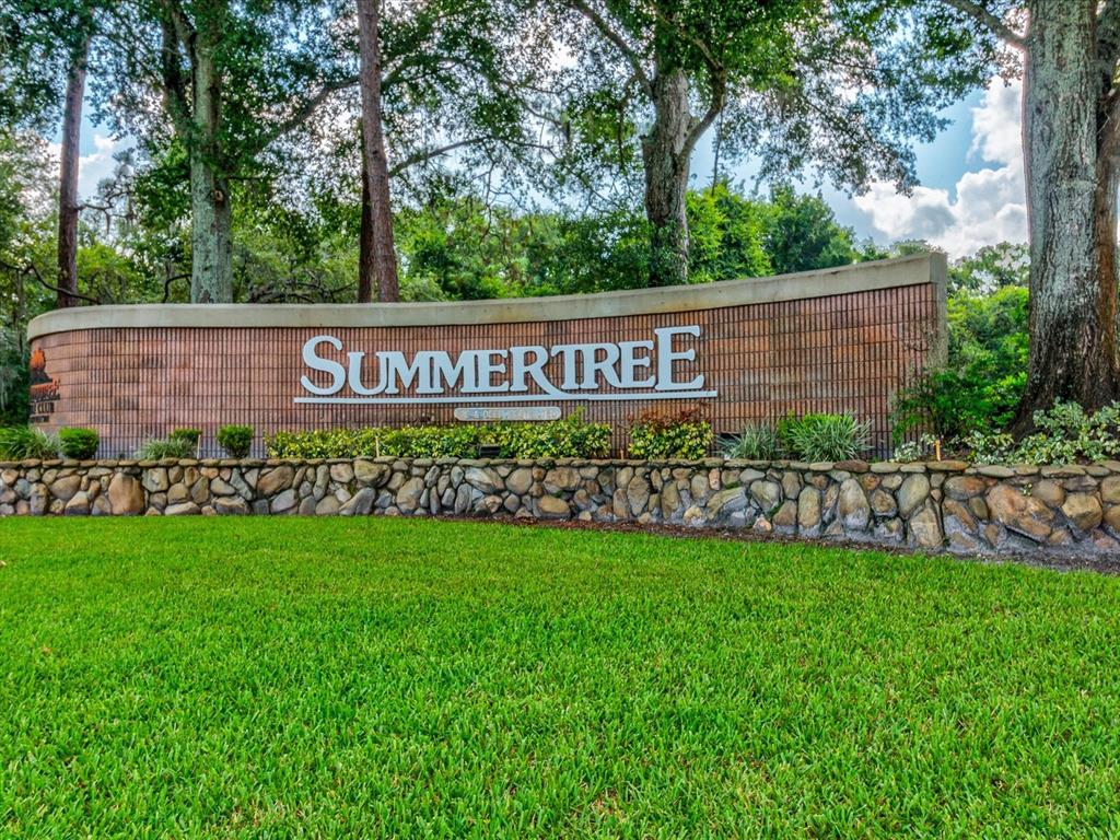 A curved brick and stone monument sign displays the name Summertree in a grassy area — 11444 MERGANSER WAY, NEW PORT RICHEY, FL
