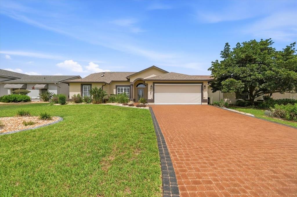A foyer with light green walls, tiled flooring, a white front door, and a wooden cabinet — 5767 SANDPIPERS DRIVE, LAKELAND, FL