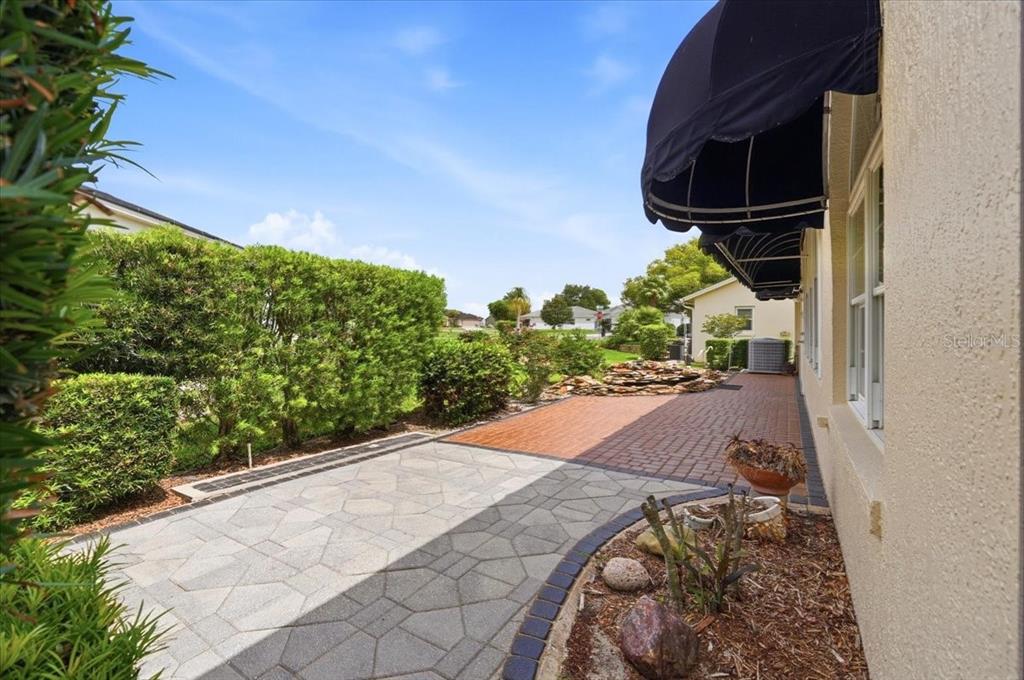 A single-story house with a tan exterior, brown roof, and a two-car garage — 5767 SANDPIPERS DRIVE, LAKELAND, FL
