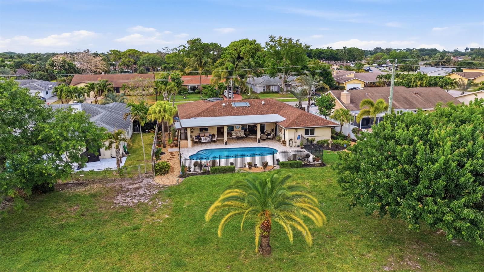 An aerial view of a house with a swimming pool and a large grassy backyard — 4780 Brandywine Drive, Boca Raton FL 33487, BOCA RATON, FL