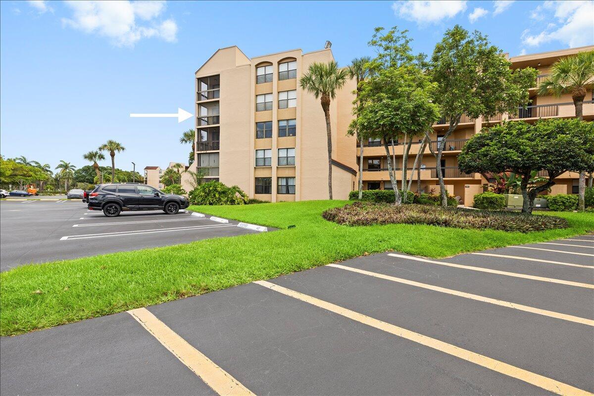 An exterior view of a multi-story apartment building with a parking lot in the foreground — 2255 Lindell Boulevard # 4401, Delray Beach FL 33444, DELRAY BEACH, FL