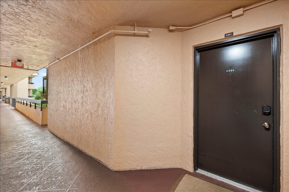 A brown apartment door with the number 4401 is located in an outdoor hallway — 2255 Lindell Boulevard # 4401, Delray Beach FL 33444, DELRAY BEACH, FL