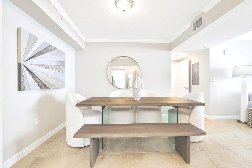A dining room features a wooden table, a matching bench, and four white upholstered chairs — 101 Plaza Real S # 606, Boca Raton FL 33432, BOCA RATON, FL