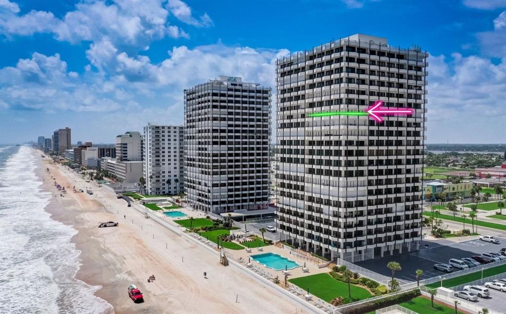 An aerial view of two high-rise beachfront condominiums with a pink arrow pointing to a balcony — 2900 N ATLANTIC AVENUE UNIT 1501, DAYTONA BEACH, FL