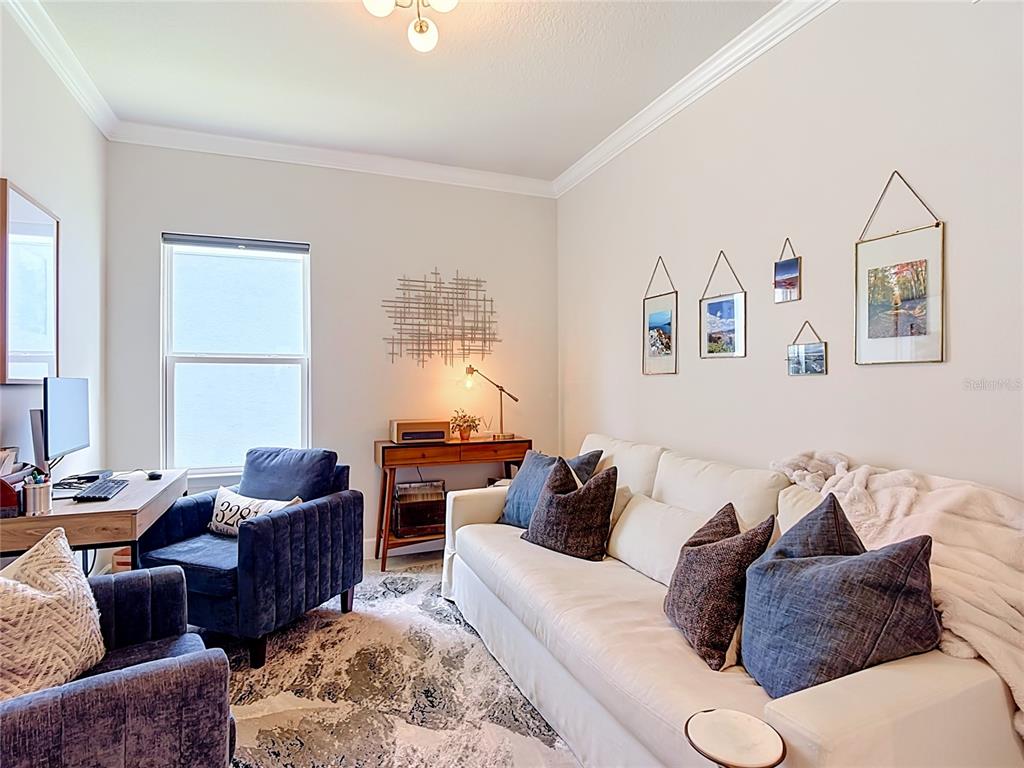 A home office features a white sofa, two blue armchairs, and a desk by a window — 5757 ANDERS WAY, ST CLOUD, FL