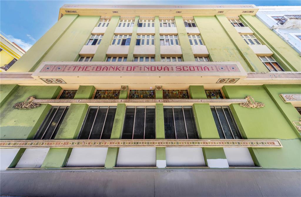 A low-angle view of a green historic building facade featuring The Bank of Nova Scotia signage — 251/253 TETUAN STREET, SAN JUAN, PR