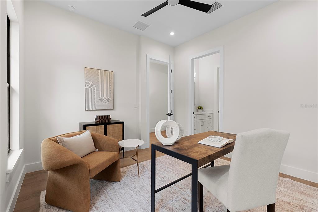 A home office features a desk, an armchair, a side table, and a doorway to a bathroom — 2505 AMHERST AVENUE, ORLANDO, FL