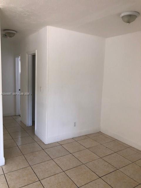 An interior view shows a room with beige tile flooring, white walls, and two ceiling lights — 1895 Venice Park Dr # B20, Miami FL 33181, MIAMI, FL