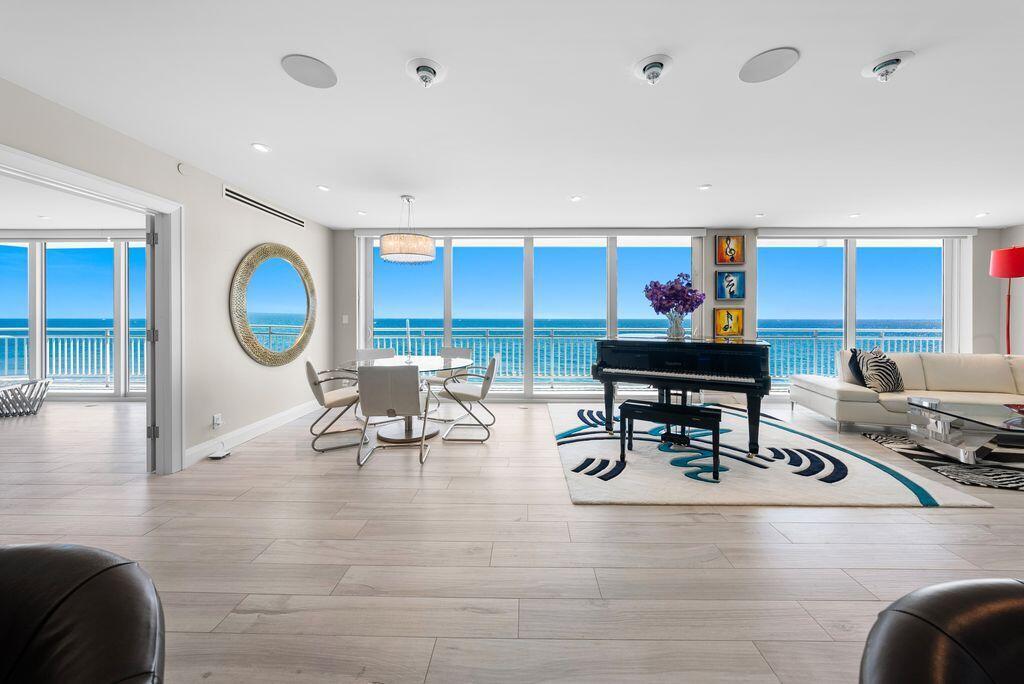 A bright living and dining area features a grand piano, ocean views, and light flooring — 2150 N Ocean Boulevard # s, Boca Raton FL 33431, BOCA RATON, FL